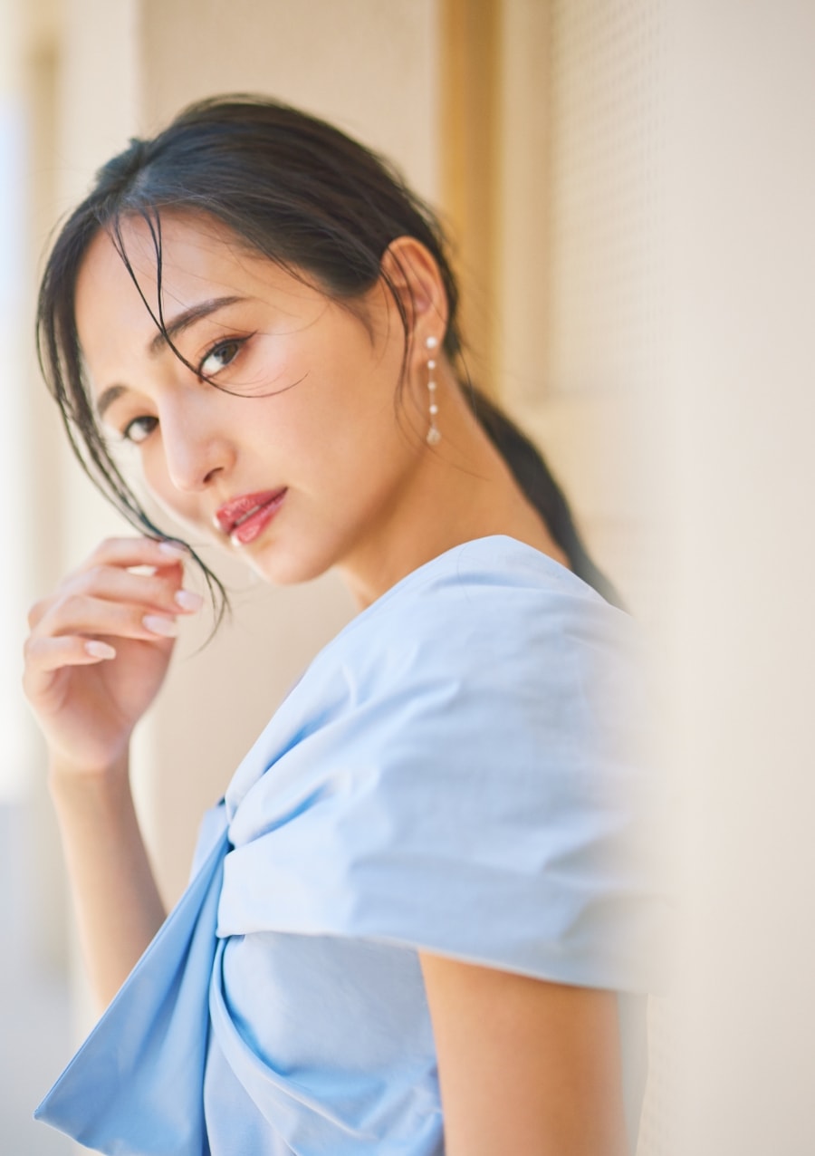 ブルーのブラウスを着た女性がふり向いている画像