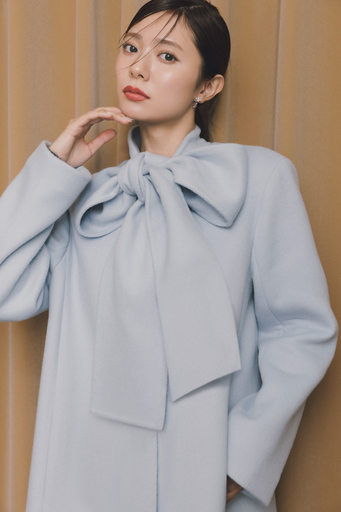 ライトブルーのワンピースを着た女性が正面を向いている画像